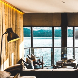 living room of beach house with large windows with view of ocean.